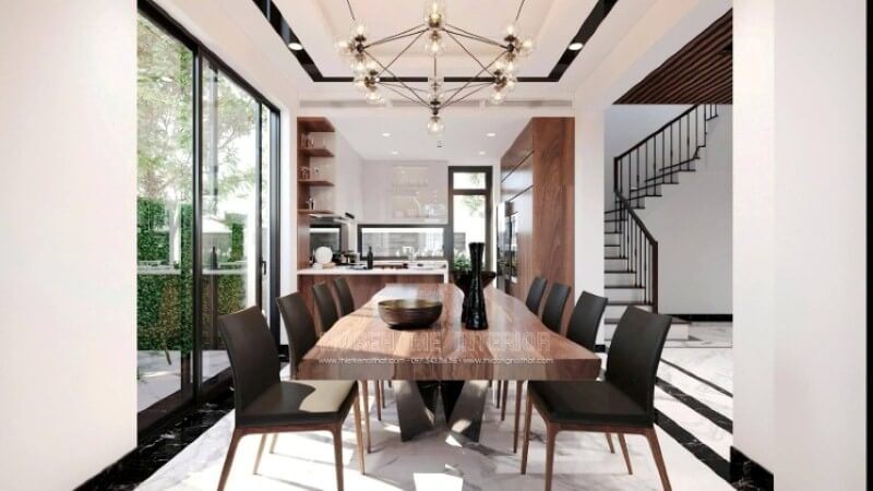 Để tạo nên vẻ đẹp tổng thể trong ý tưởng bố trí nội thất phòng ăn biệt thự Vinhomes Imperia Hải Phòng, sự chú ý đặc biệt được đưa đến vật liệu lát nền. Với sự sắp đặt nghệ thuật như trong mẫu bố trí trên đây, đá tự nhiên được bao bọc xung quanh bởi khung viền đá đen để thể hiện ranh giới rõ ràng của phòng ăn. Trên trần thạch cao được tô điểm thêm đường viền vuông vắn và đèn âm tường, tạo ra hiệu ứng độc đáo cho không gian bếp.